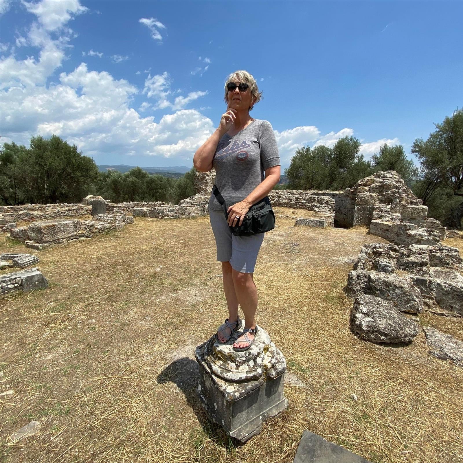 Mrs. Downs takes a moment at the ruins in Sparta, Greece.